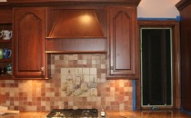 Backsplash design piece over range